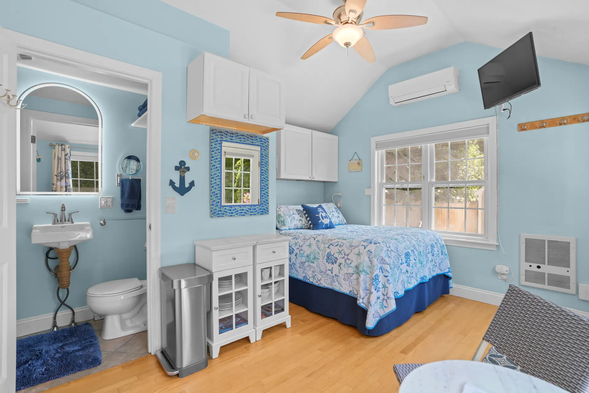 A bright coastal sleeping space with an adjoining bath